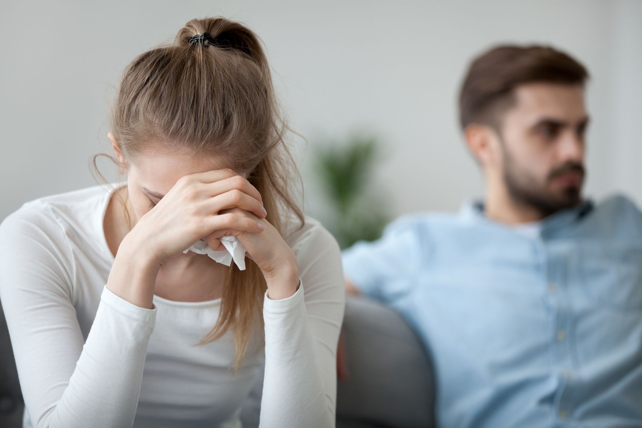Mann und Frau diskutieren das Thema Eifersucht auf Couch