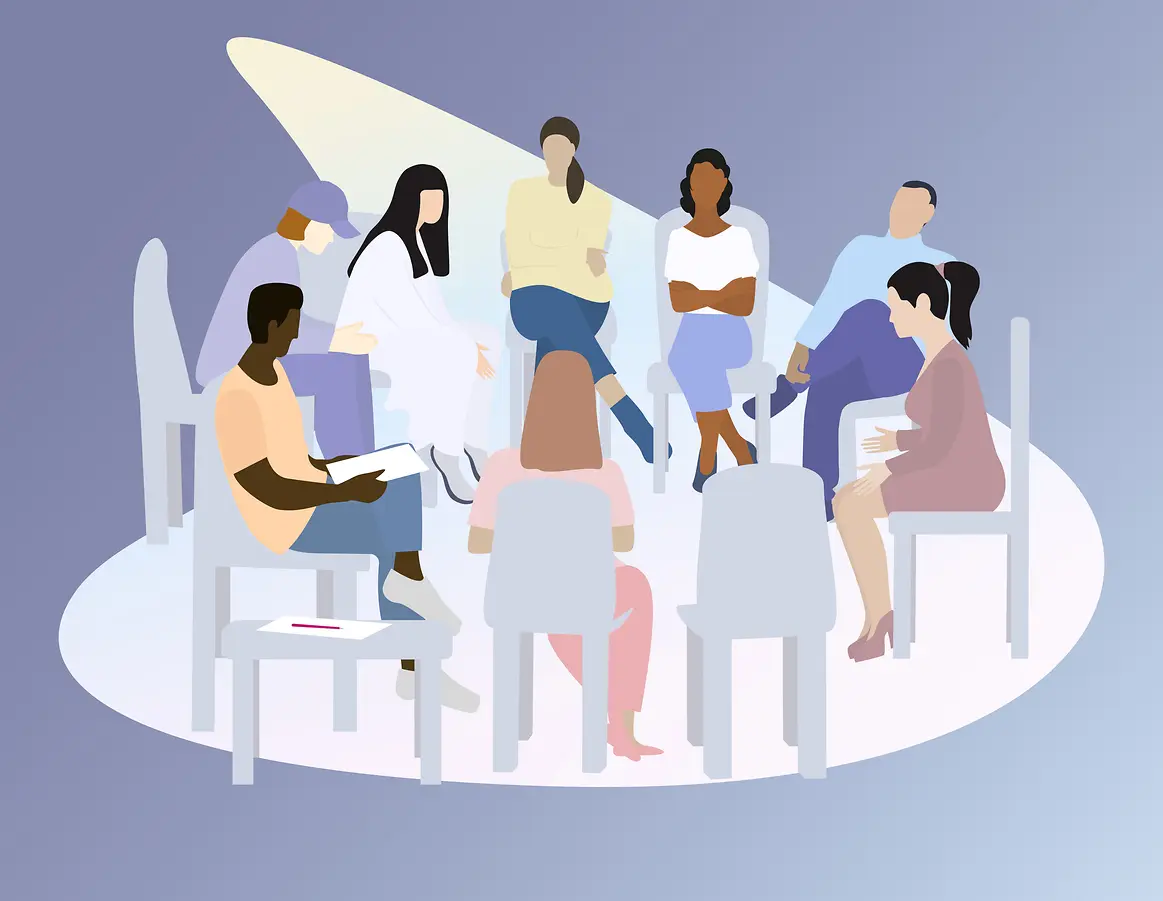 Eine Menschengruppe sitzt im Stuhlkreis